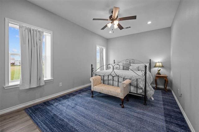 bedroom with ceiling fan and dark hardwood / wood-style flooring