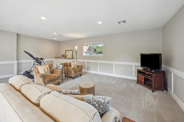 carpeted living room featuring a textured ceiling