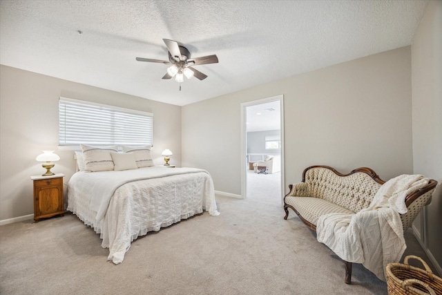 carpeted bedroom with a textured ceiling and ceiling fan