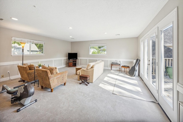 carpeted living room with a textured ceiling