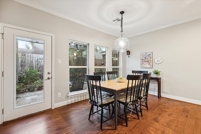 dining space with dark wood-type flooring and ornamental molding