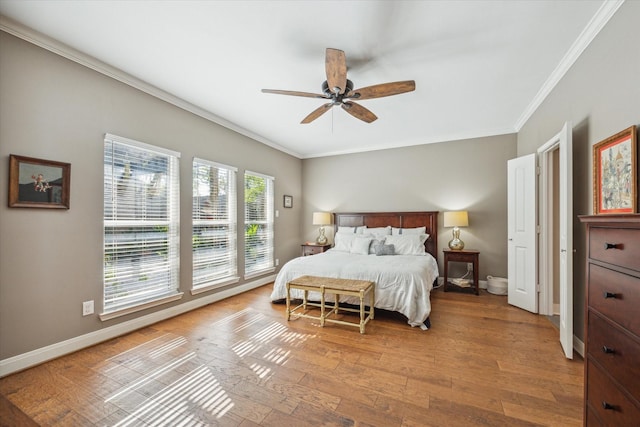 bedroom with light hardwood / wood-style flooring, ceiling fan, and ornamental molding