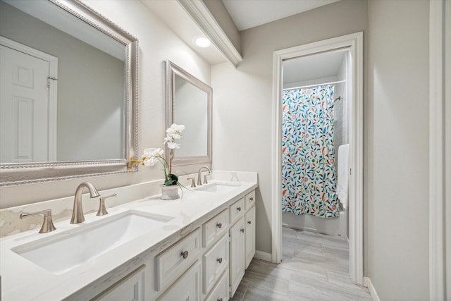 bathroom with shower / bath combination with curtain and vanity