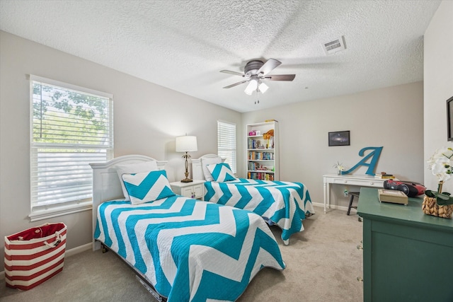 bedroom with carpet, a textured ceiling, and ceiling fan