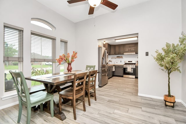 dining space with ceiling fan and light hardwood / wood-style flooring