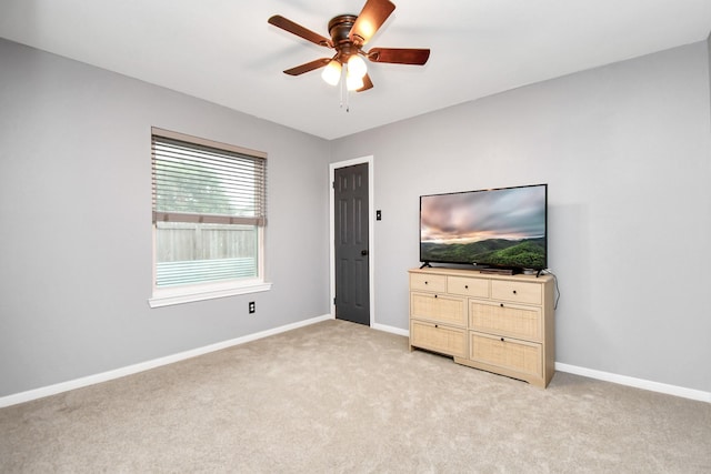 bedroom featuring light colored carpet and ceiling fan