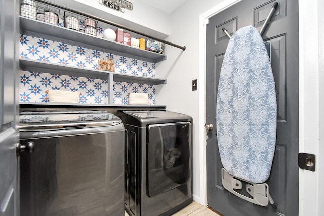 laundry area with washing machine and dryer and light tile patterned flooring