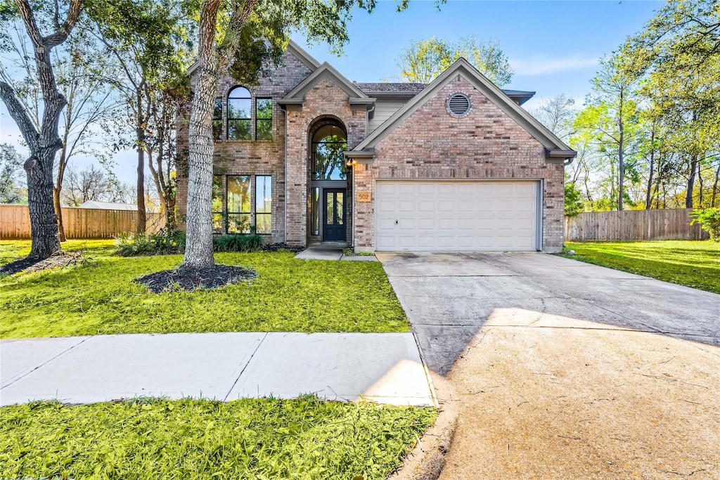 view of property with a front yard and a garage