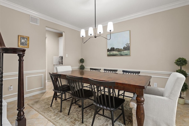 tiled dining space with an inviting chandelier and ornamental molding