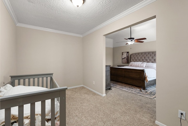 carpeted bedroom featuring a textured ceiling, ceiling fan, and ornamental molding