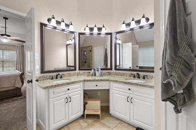 bathroom with vanity, ceiling fan, and walk in shower