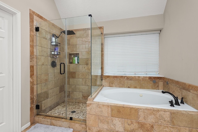 bathroom with shower with separate bathtub and vaulted ceiling