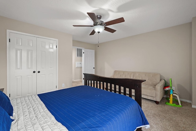 bedroom featuring ceiling fan, a closet, and carpet