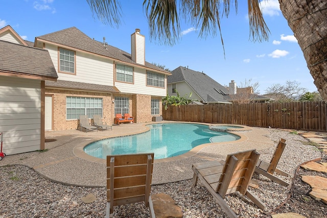 view of pool featuring a patio area and an in ground hot tub