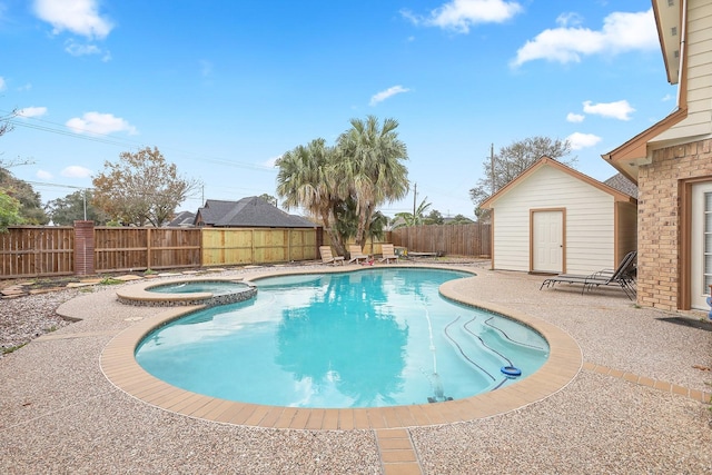 view of swimming pool with an in ground hot tub and a patio