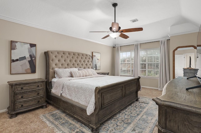 carpeted bedroom featuring ceiling fan and crown molding