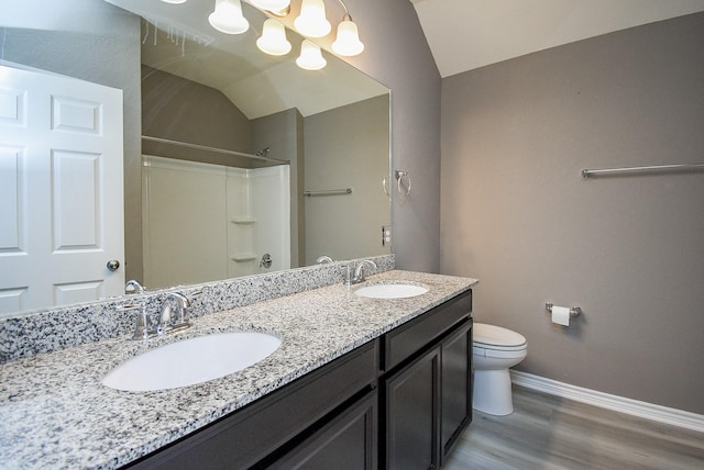 bathroom featuring a shower, lofted ceiling, toilet, vanity, and hardwood / wood-style flooring