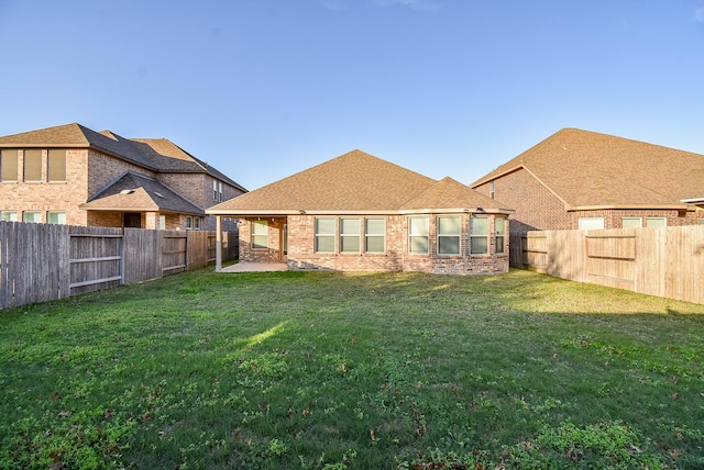 rear view of property with a yard