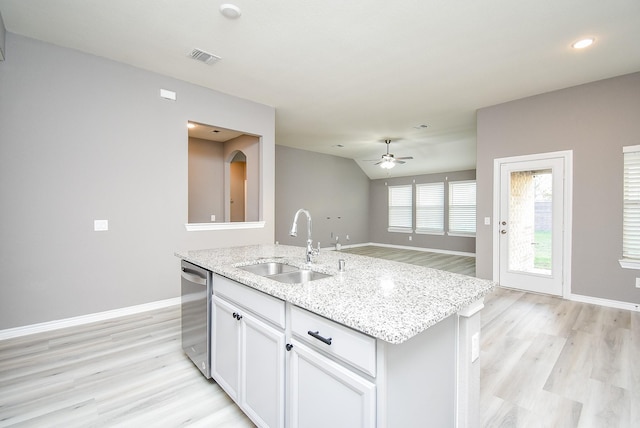 kitchen with white cabinetry, dishwasher, sink, ceiling fan, and a center island with sink