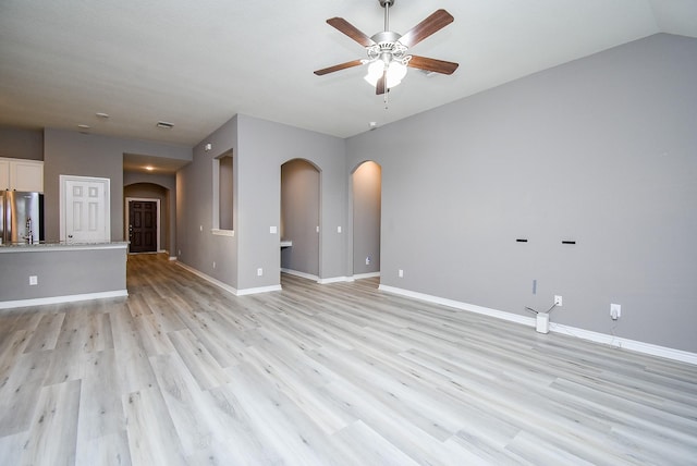 unfurnished living room featuring light wood-type flooring and ceiling fan