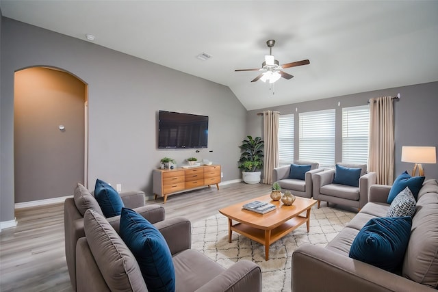 living room featuring ceiling fan, light hardwood / wood-style floors, and lofted ceiling