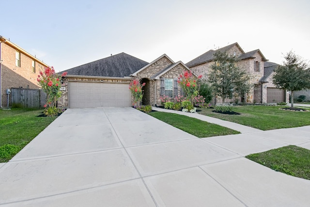 view of front of house featuring a garage and a front lawn