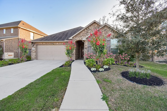 view of front of home with a garage and a front lawn