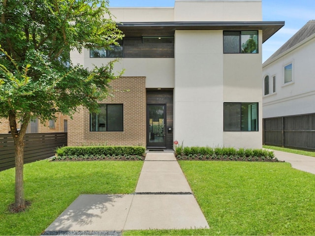 contemporary house featuring a front yard