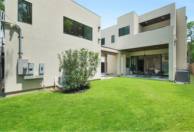 back of house with a patio, central AC unit, and a lawn