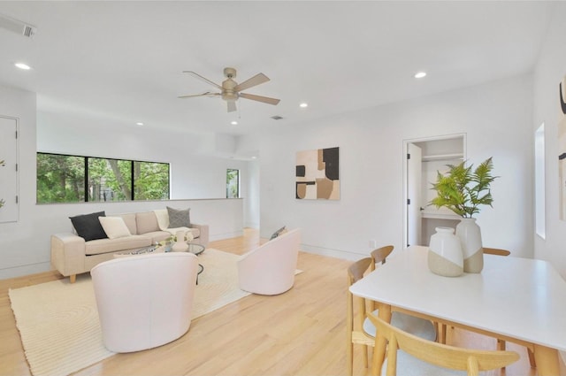 living room with ceiling fan and light wood-type flooring