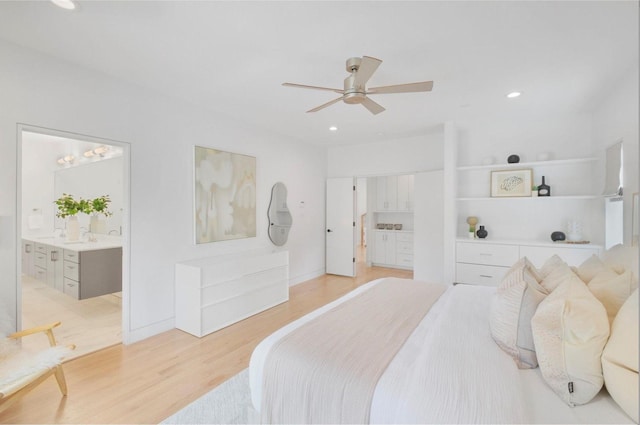 bedroom featuring ensuite bathroom, ceiling fan, and light hardwood / wood-style flooring