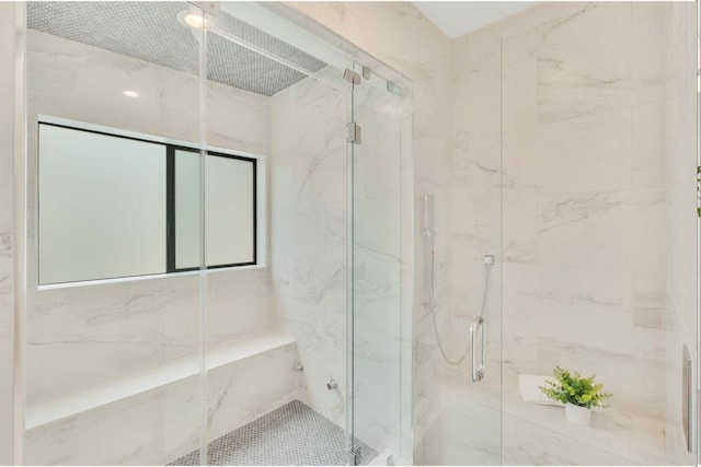 bathroom featuring a shower with shower door