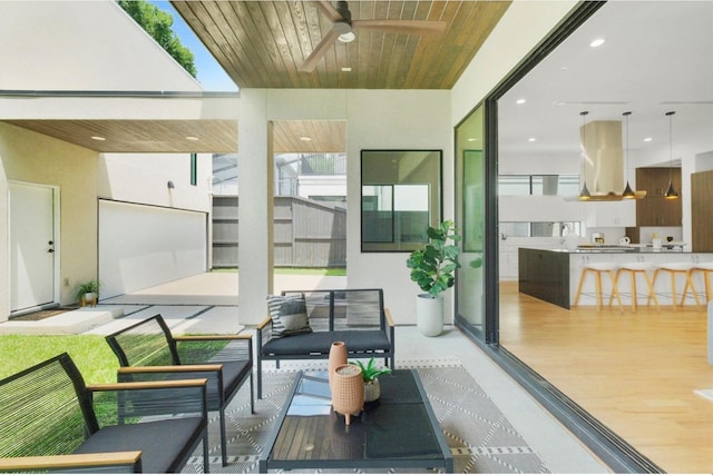 sunroom / solarium with ceiling fan and wooden ceiling