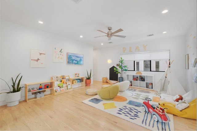 playroom with light wood-type flooring and ceiling fan