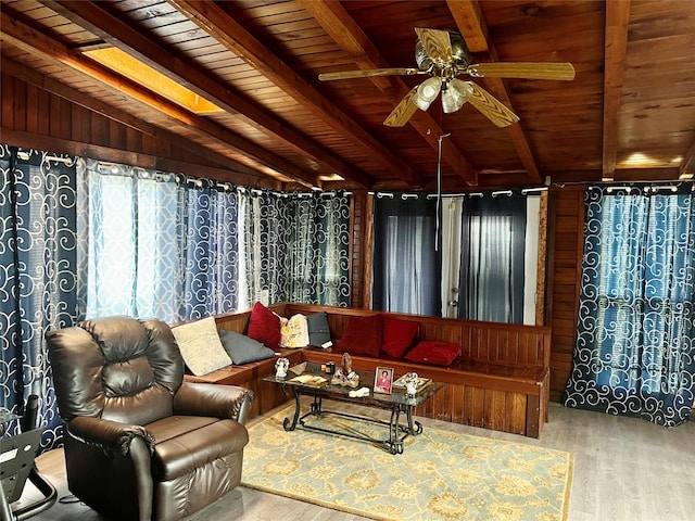 living room with hardwood / wood-style floors, vaulted ceiling with beams, ceiling fan, and wood ceiling