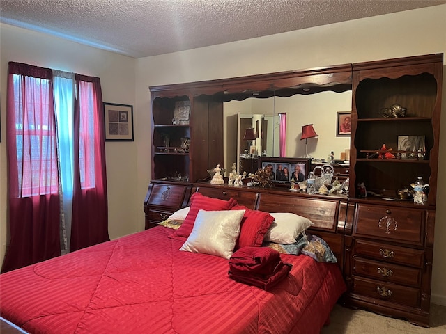 bedroom featuring carpet flooring and a textured ceiling