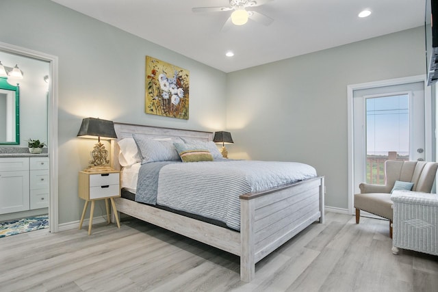 bedroom featuring light hardwood / wood-style flooring, ensuite bath, and ceiling fan