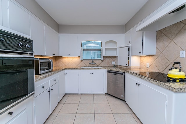 kitchen featuring black appliances, ventilation hood, light tile patterned floors, tasteful backsplash, and white cabinetry