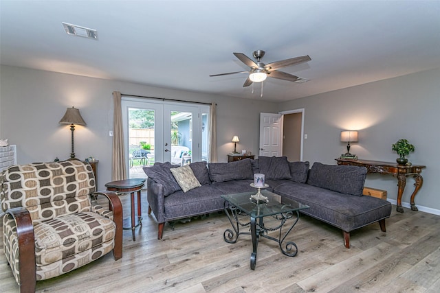 living room featuring ceiling fan, light hardwood / wood-style flooring, and french doors