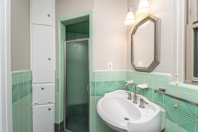 bathroom featuring sink, walk in shower, and tile walls