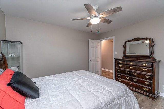 bedroom with light wood-type flooring and ceiling fan