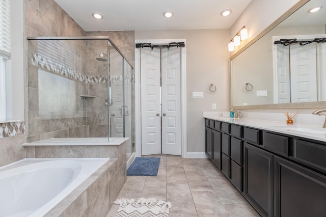 bathroom featuring tile patterned floors, vanity, and independent shower and bath