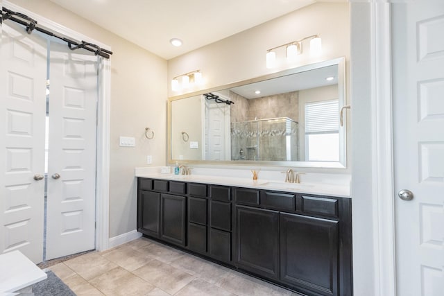 bathroom featuring tile patterned floors, an enclosed shower, and vanity