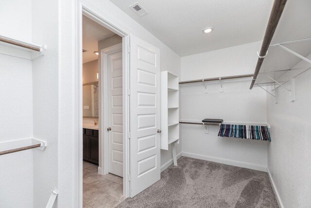 spacious closet featuring light carpet