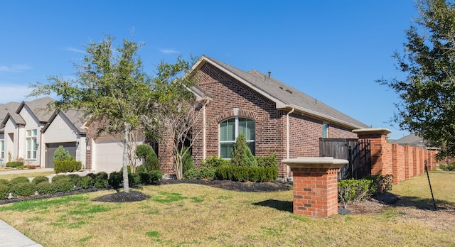 view of front of house with a garage and a front lawn