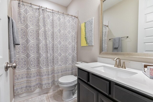 bathroom with toilet, vanity, walk in shower, and tile patterned flooring