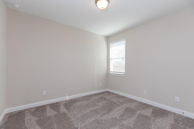 unfurnished room featuring carpet