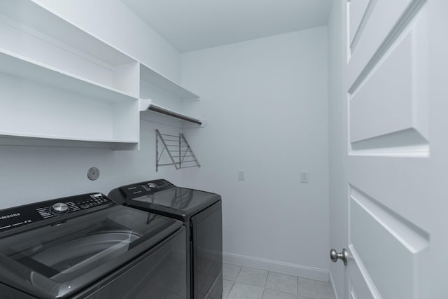 laundry room with separate washer and dryer and light tile patterned flooring