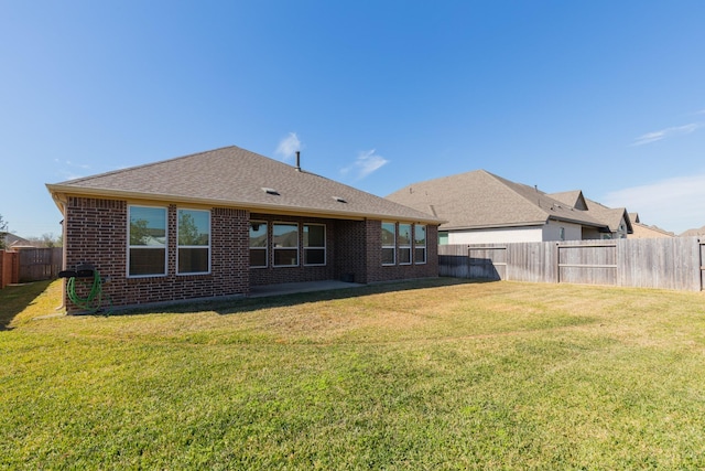 back of property featuring a yard