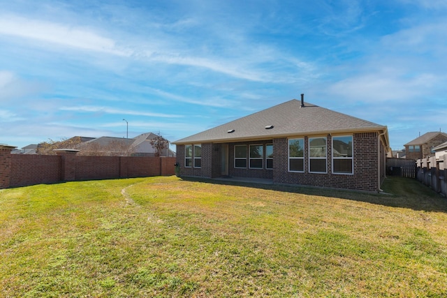 rear view of house with a yard